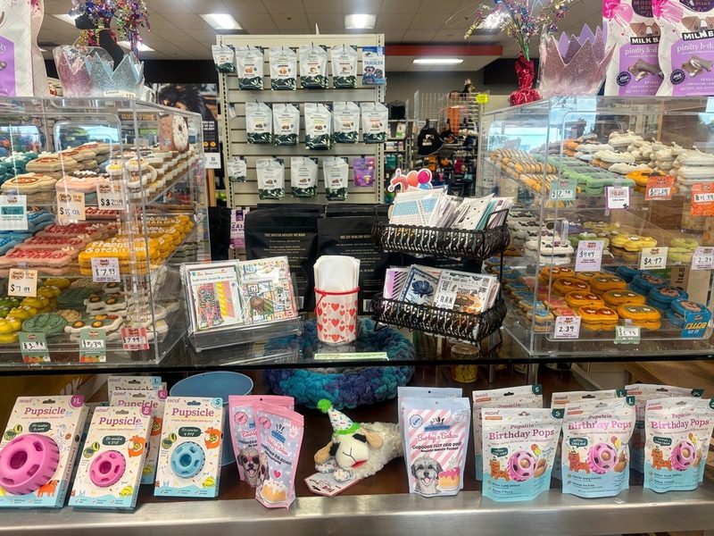 Decorated dog cookies and donuts in the bakery case
